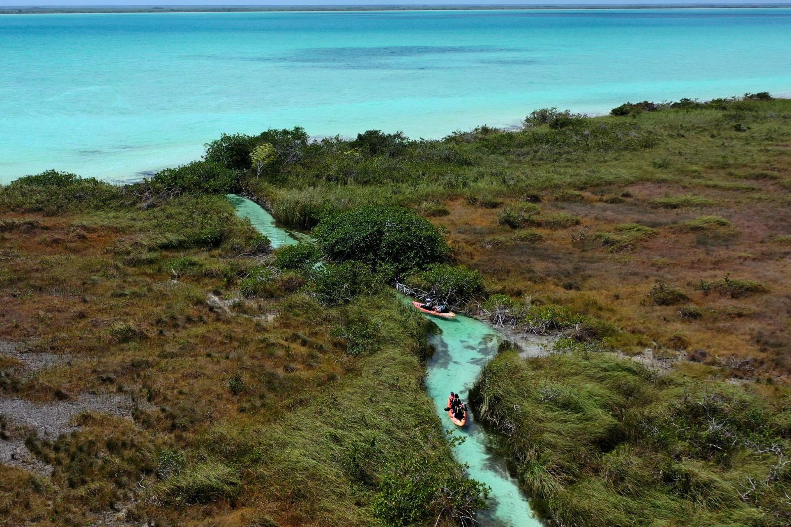 Kayaks crossing the Chunyaxché lagoon inside the Sian Ka'an Biosphere Reserve