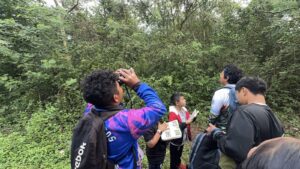 Maya children looking up to spot birds during the CTSK children´s birding walk