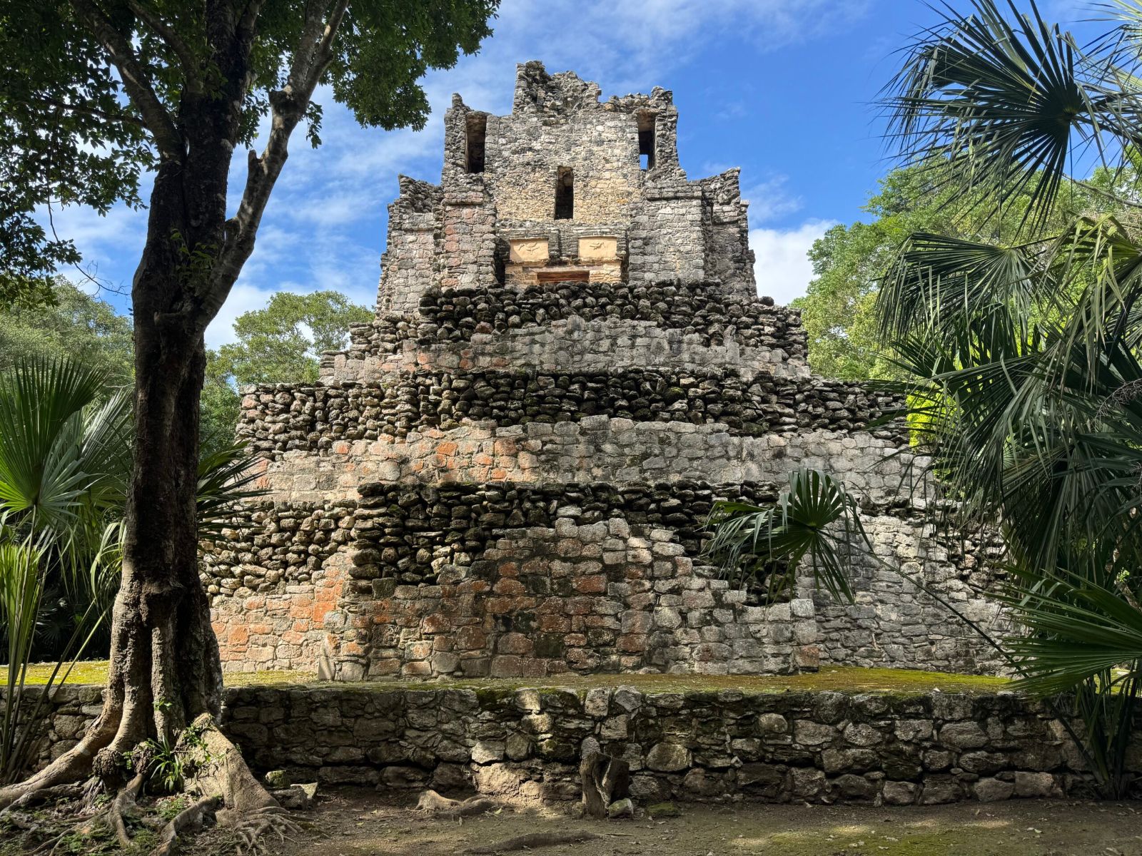 El Castillo pyramid rising above the jungle at the Muyil archaeological zone near Tulum