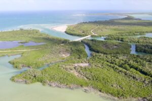 Aerial view of the canal system meeting the white sand beach and boca of Sian Ka´an