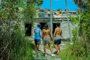 Visitors and Maya guide exploring the Xlapak temple in the jungle during the Ancient Canal tour