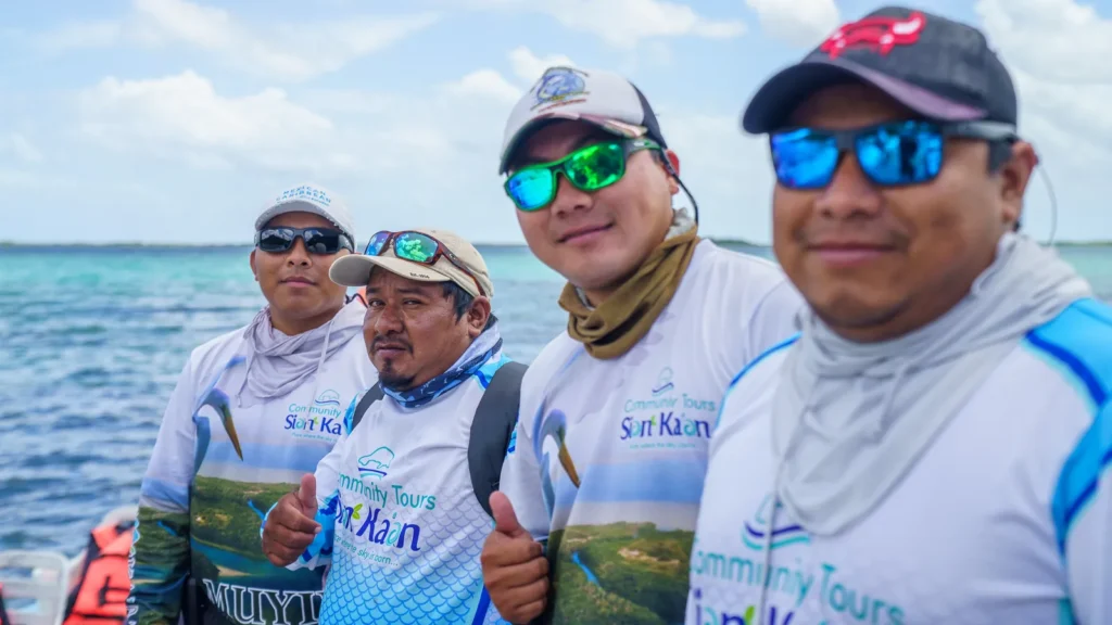 Guides and captains of the cooperative smiling on the water