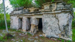 Stone Maya temple of Xlapak with three doorways, surrounded by jungle in Sian Ka'an